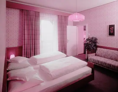 a bedroom with two beds and a window at Plonerhof in Lagundo