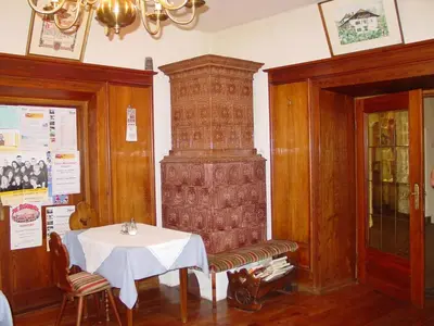 a dining room with a table and a large pillar at Plonerhof in Lagundo