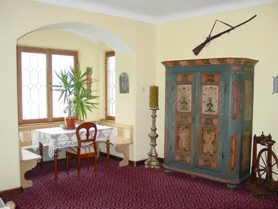 a room with a table and a blue cabinet at Plonerhof in Lagundo