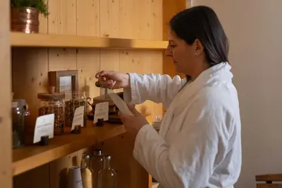 a woman is standing in front of a shelf at Phi Hotel Bellamonte in Predazzo