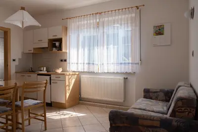 a kitchen with a table and a dining room at Ferienwohnung im Haus Texel III in Parcines