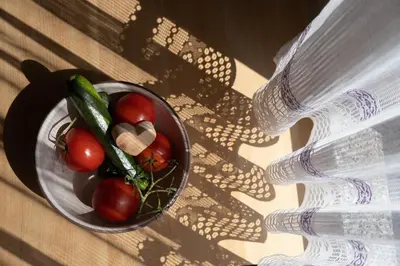 a bowl of vegetables on a table next to a bottle at Ferienwohnung im Haus Texel III in Parcines