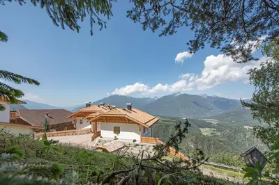 a house on a hill with mountains in the background at Forchnerhof Panorama - App 3 Täler Blick in Rodengo