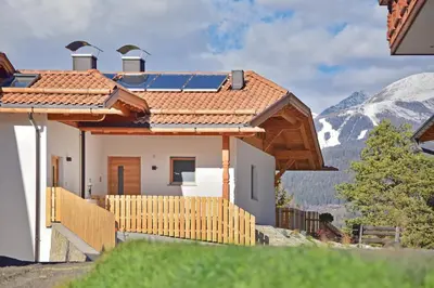 a house with a roof with mountains in the background at Forchnerhof Panorama - App 3 Täler Blick in Rodengo