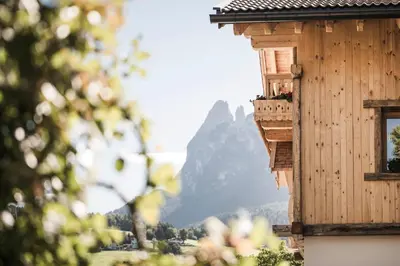 a balcony of a house with a mountain in the background at Huberhof in Fiè