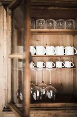 a shelf filled with cups and saucers on it at Huberhof in Fiè