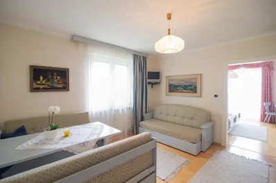 a living room with a couch and a table at Haus St. Valentin in Appiano sulla Strada del Vino