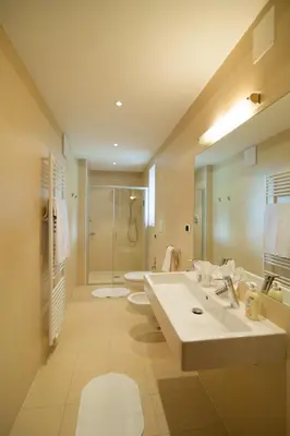 a large bathroom with a sink and a shower at Haus St. Valentin in Appiano sulla Strada del Vino