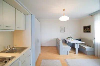 a kitchen with a table and a dining room at Haus St. Valentin in Appiano sulla Strada del Vino