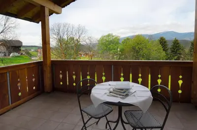 a table and chairs on a balcony with a view at Urthalerhof in Castelrotto
