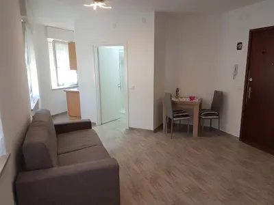 a living room with a couch and a table at Giuchry Apartment in Merano