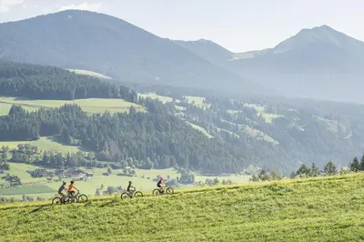 a group of people riding bikes down a hill at Hotel Elisabeth in Chienes