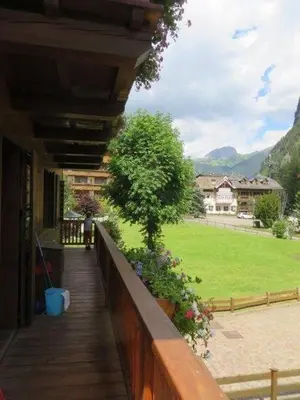 a porch of a house with a view of a field at El Tobià in Campitello