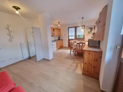 a living room with a kitchen and a dining room at El Tobià in Campitello