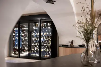a wine cellar with a display of bottles of wine at Hotel Weingut Stroblhof in Appiano sulla Strada del Vino