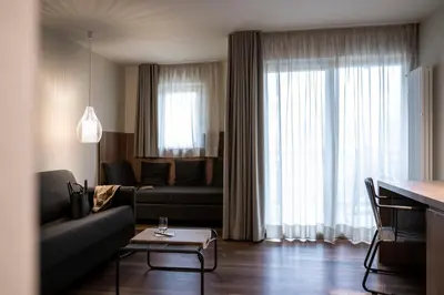 a living room with a couch and a table at Hotel Weingut Stroblhof in Appiano sulla Strada del Vino