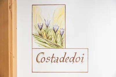 a painting of a flower with the word cockdatabase at Ciasa Soplà in San Cassiano