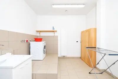 a laundry room with a washer and dryer at Ciasa Soplà in San Cassiano