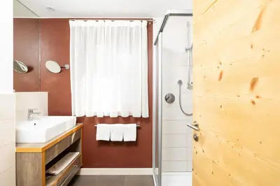 a bathroom with a sink and a shower at Ciasa Soplà in San Cassiano