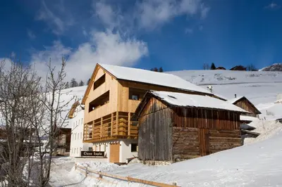 a log cabin in the snow with snow at Ciasa Soplà in San Cassiano