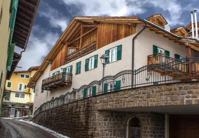 a building with balconies on the side of a street at Casa Zone in Tesero