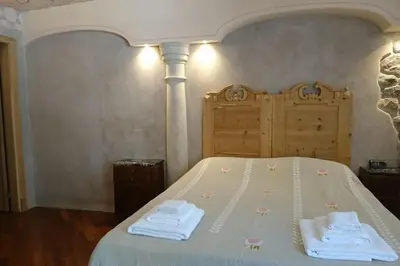 a bedroom with a bed with towels on it at Ugo Art Lodge Classic in Bolzano