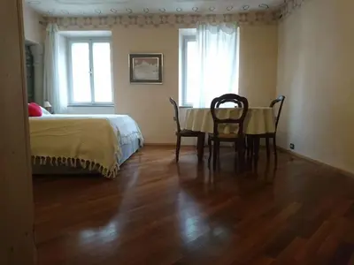 a bedroom with a table and chairs and a bed at Ugo Art Lodge Classic in Bolzano