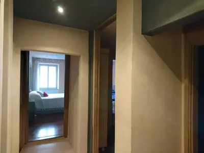 a room with a bedroom with a bed and a mirror at Ugo Art Lodge Classic in Bolzano