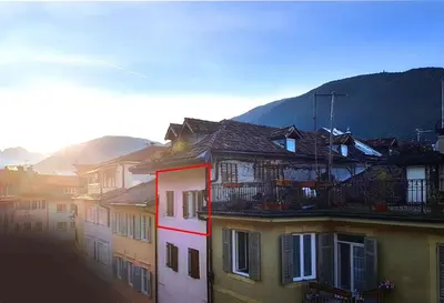 a group of buildings with mountains in the background at Ugo Art Lodge Classic in Bolzano