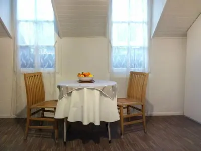 a table with two chairs and a bowl of fruit on it at Ugo Art Lodge Bright in Bolzano