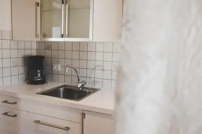 a kitchen with a sink and a coffee maker at Guesthouse Christine in Marlengo
