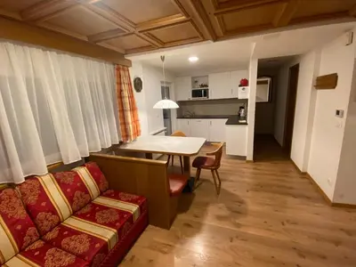 a living room with a couch and a table at Apartaments Galina in Selva di Val Gardena