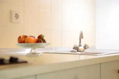 a kitchen counter with a bowl of fruit on a sink at Residence Bacher in Valdaora
