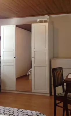 a room with white doors and a wooden ceiling at Quater Apartments - Cavalese in Cavalese