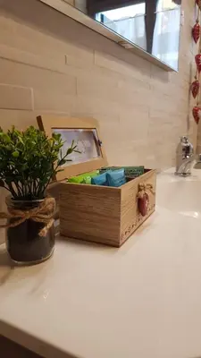 a wooden box sitting on top of a bathroom sink at Quater Apartments - Cavalese in Cavalese