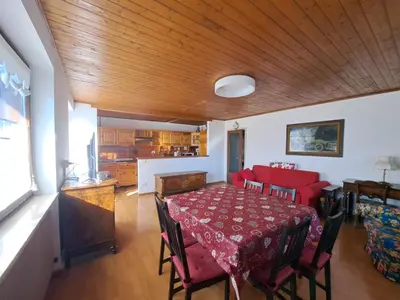 a dining room with a red table and chairs at Quater Apartments - Cavalese in Cavalese
