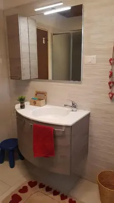a bathroom with a sink and a mirror at Quater Apartments - Cavalese in Cavalese