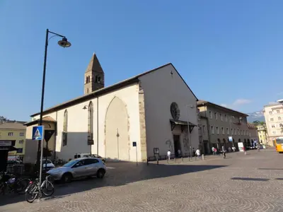 a small car parked in front of a church at Apartment Duomo in Bolzano