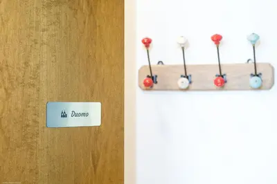 a sign that reads hit durango hanging on a door at Apartment Duomo in Bolzano