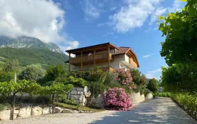 a house on a hill with a stone wall at Sonnenhof Tramin - Adults Only in Termeno