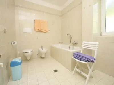 a bathroom with a tub and a toilet and a sink at Paderlafoderhof in Laion