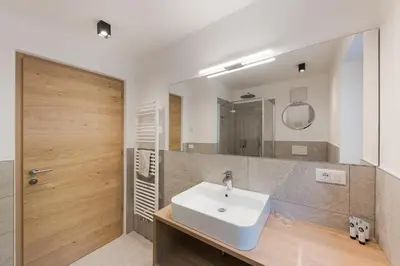 a bathroom with a sink and a mirror at Aparthotel Abiná Lana Höhe in Lana