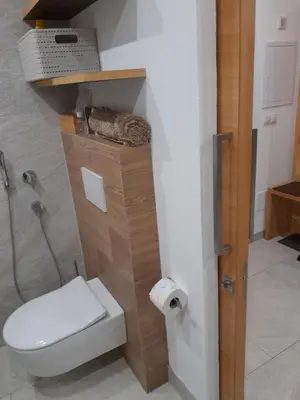 a bathroom with a toilet and a toilet paper dispenser at Chalet Schwarzenstein in Campo Tures