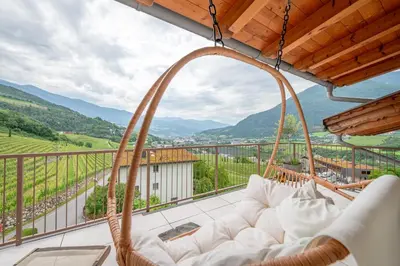 a swinging couch on a balcony with a view at Haus Karin view in Brixen