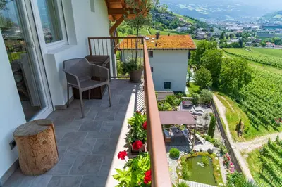 a balcony of a house with a view of a vineyard at Haus Karin view in Brixen