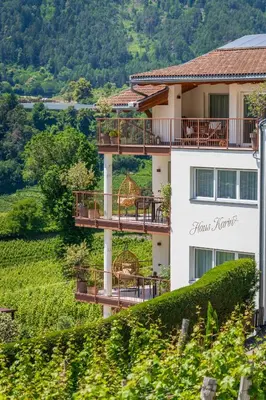 a building with balconies on the side of a hill at Haus Karin view in Brixen
