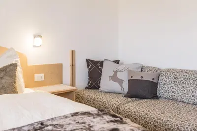 a living room with a couch and pillows at Sonnleitn in Laion