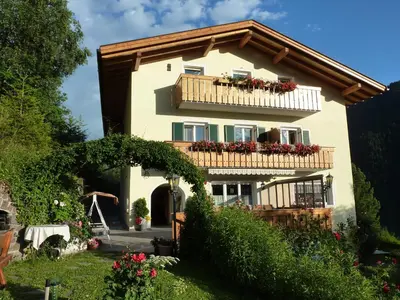 a house with a balcony with flowers on it at Sonnleitn in Laion