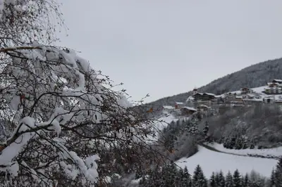 a snow covered mountain with a village in the background at Sonnleitn in Laion