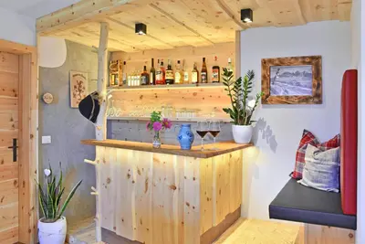 a wooden bar with two glasses of wine at Kircherhof in Bressanone